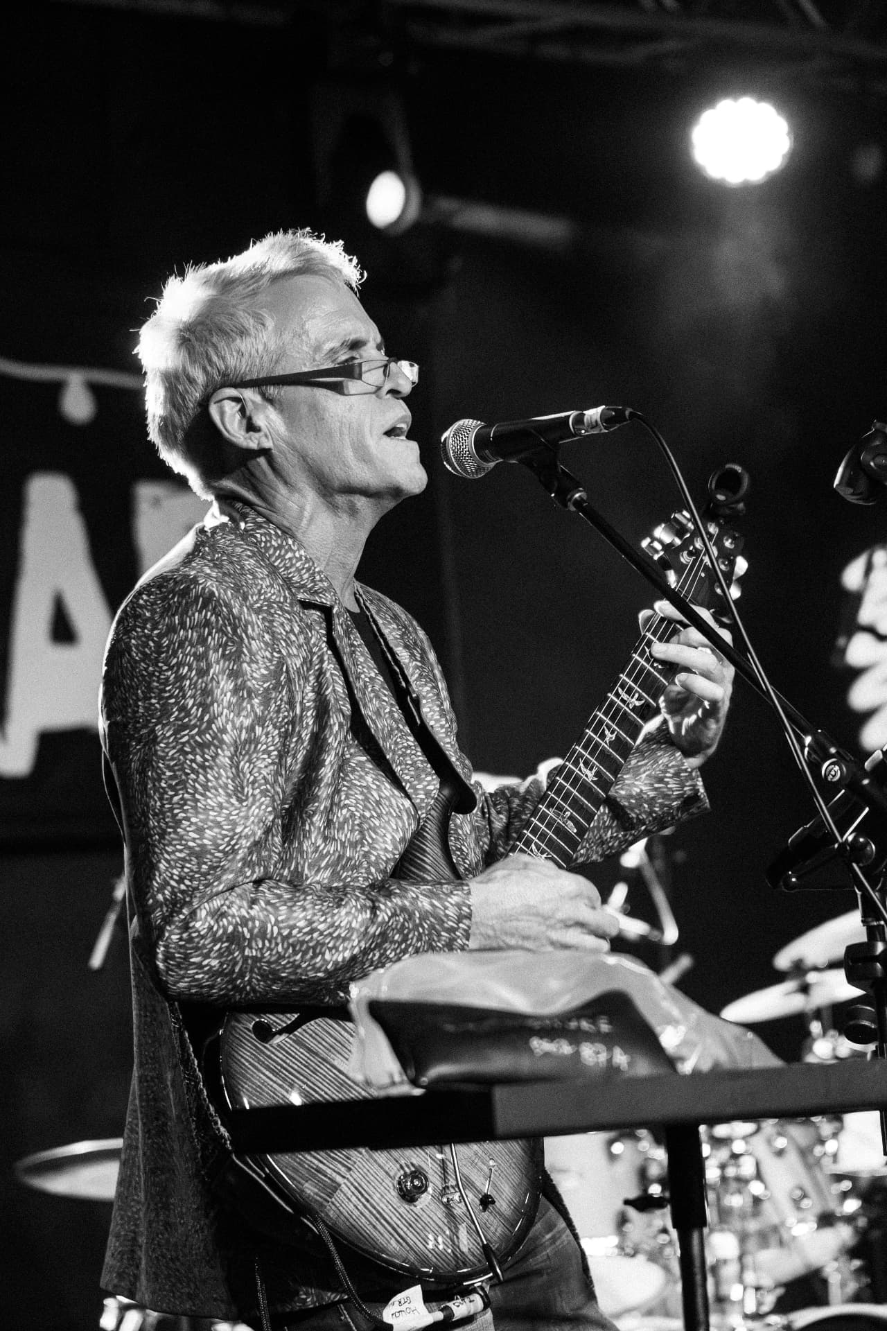Black and white portrait of Groove Dr B playing guitar